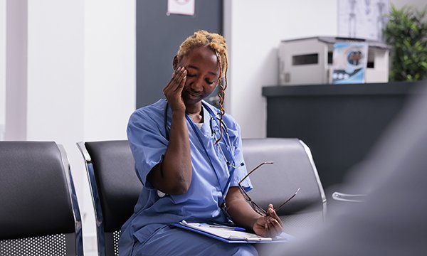 Photo of tired nurse, illustrating story about nurses' views on how to reduce burnout