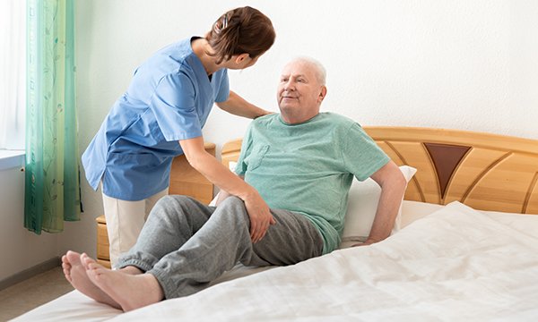 Photo of community nurse caring for patient, illustrating story about new standards of practice