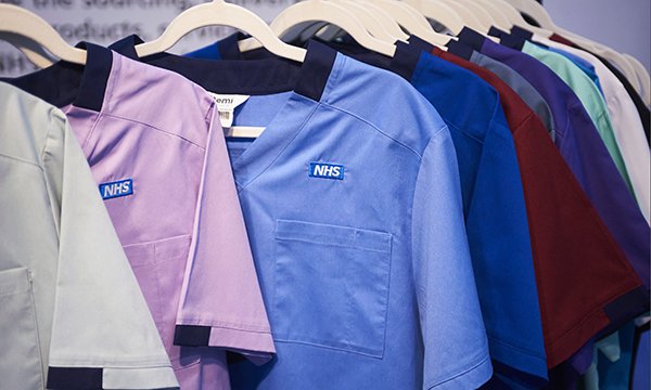 Variety of NHS uniforms displayed together on hanger to show the wide colour palette use to distinguish between professionals and roles