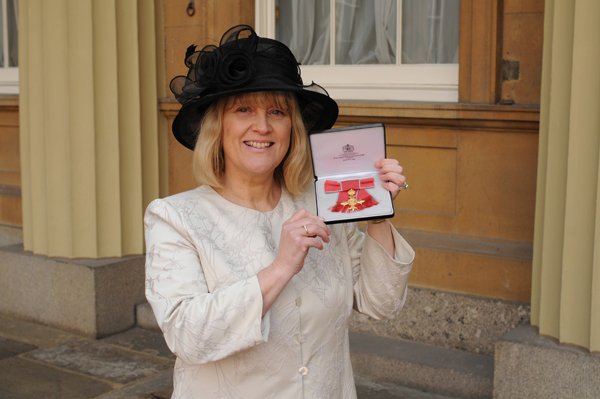 Candice Pellett holding the Queen's 90th birthday medal