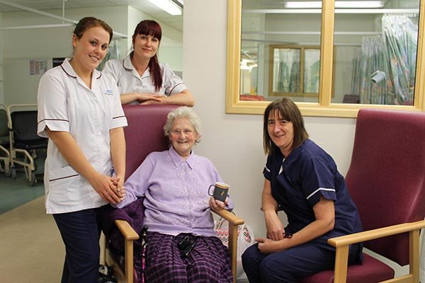 Patient Joan Riley enjoys a cuppa in the discharge suite. Pictured with discharge facilitator team lead Linda Smith and care support workers Jennifer McLaren and Leanne Morrissey.