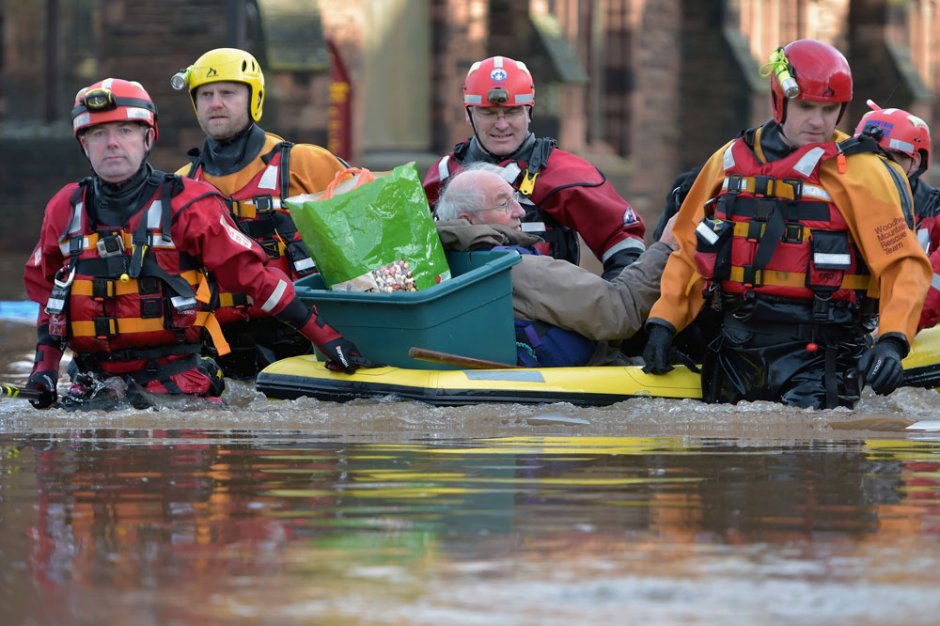 A rescue team helps to evacuate people from their homes after Storm Desmond caused flooding on December 6, 2015 in Carlisle. Photo by Jeff J Mitchell/Getty