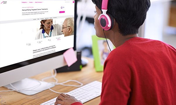 Picture shows a woman wearing headphones sitting in front of a computer screen. Nurses can take a free online course on targeted cancer treatments. Launching in February, it comprises two to three hours of learning per week for five weeks.