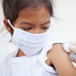 Picture shows a child receiving an injection