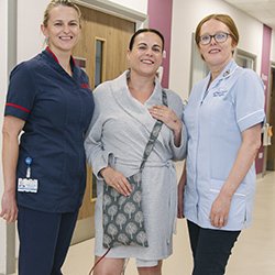 Picture shows ward manager Donna St John (left) and staff nurse Pip Page-Davies (right) with Hazel Carter, a patient who uses one of the drainage bag covers made by Ms Page-Davies and other nurses