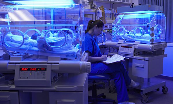 Nurse with babies in incubators