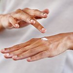 Applying moisturiser to hands