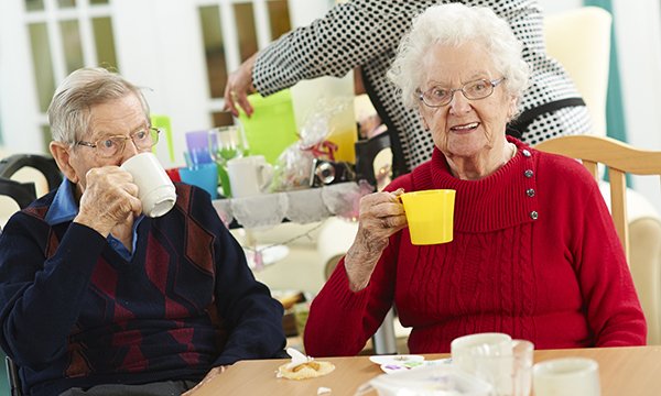 Nursing home residents enjoying a cup of tea