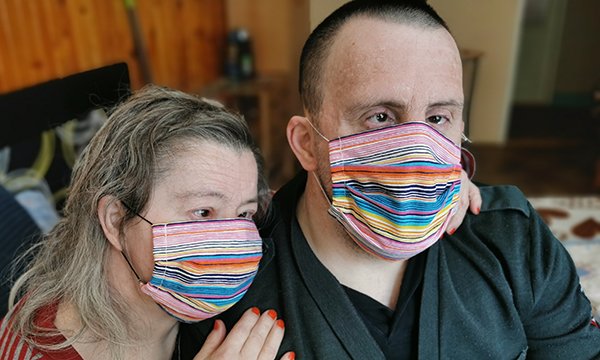 Picture shows a couple with Down's syndrome weating face masks. A nurse academic says figures on of learning disability deaths from COVID-19 are needed now to help prevent unnecessary deaths