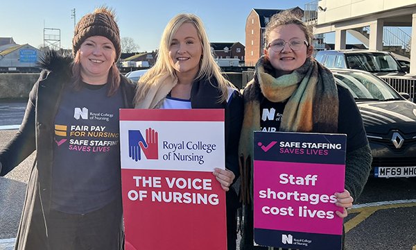 Nurses Abbie and Nettie, and health visitor Lorretta, holding placards on the picket line in Great Yarmouth