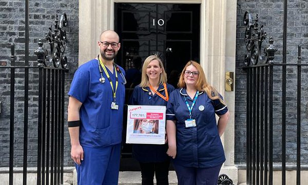 GMB union organiser and nurse Holly Turner (middle) with front-line NHS workers delivering the petition to Downing Street