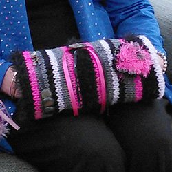 A person wearing a twiddle muff which helps keep patients active and keep their hands warm