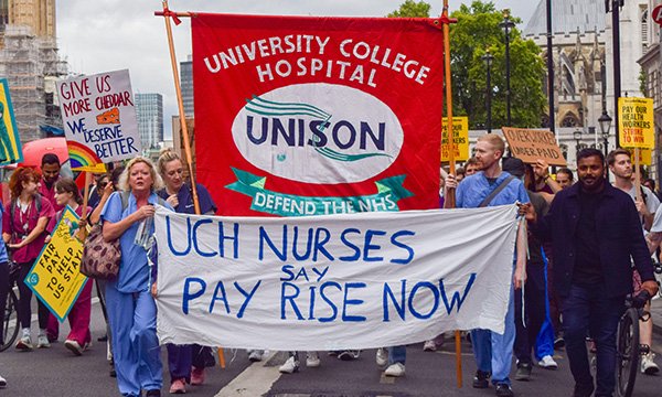 Striking NHS workers with Unison banner