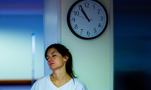 Picture shows a model posing as a tired nurse in a hospital at night. Pressures facing nursing remain a particular concern and the health service is relying on unpaid overtime and the goodwill of the wider workforce, a report says.