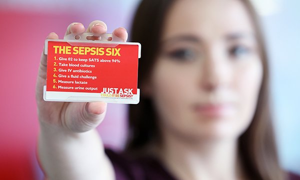 Katie Dutton holds the sepsis six card