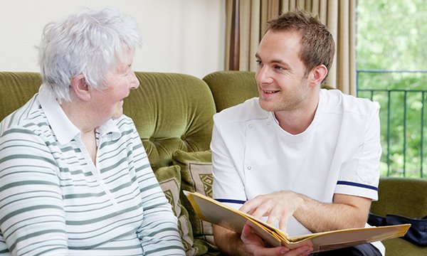 A nurse discusses a care plan with an older woman