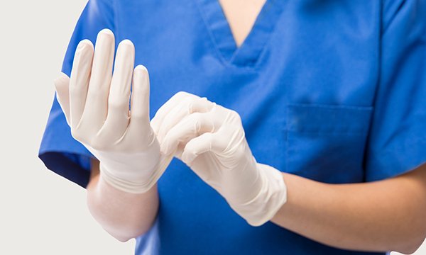 Nurse using latex gloves
