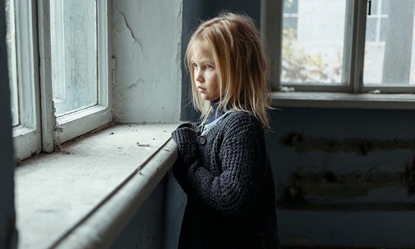 child looks out of window
