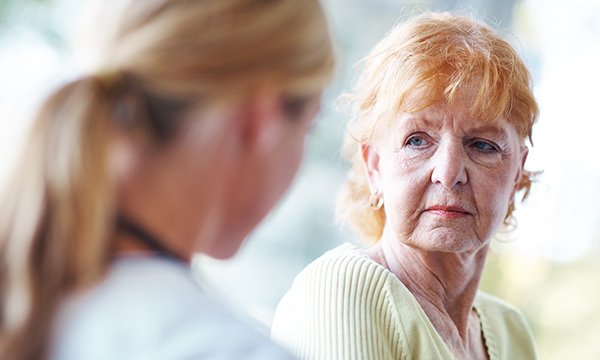 woman looking at healthcare professional