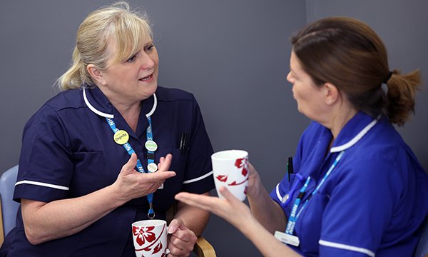 Two nurses talking. Photo: Tim George