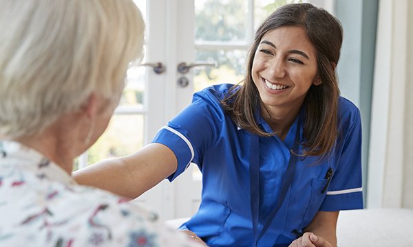 Nurse talking to elderly lady in care home. Picture: iStock