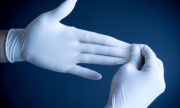 Removing plastic gloves from hands