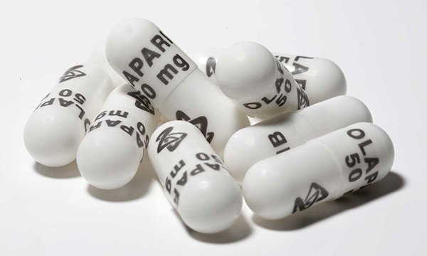 Picture shows olaparib capsules. Olaparib inhibits enzymes that repair DNA in cancer cells. 