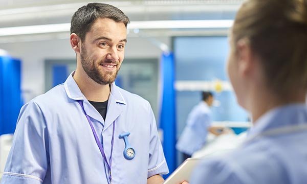 Male nurse being kind to a colleague