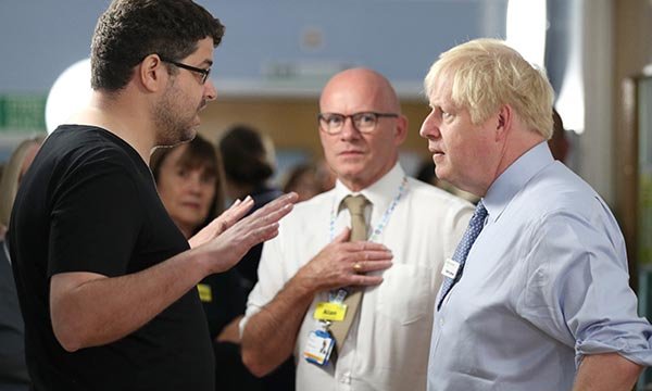 Omar Salem (left) confronts Boris Johnson as Alan Gurney (centre) looks on Picture: PA