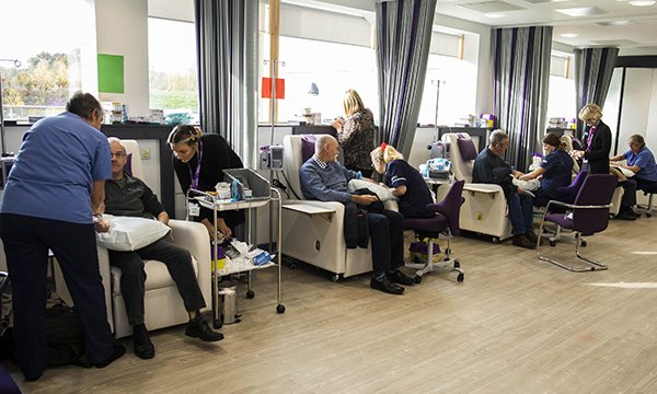 Picture shows men sitting in a row of chairs receiving free blood tests to check their PSA (prostate specific antigen) levels to screen for prostate cancer. More than 2,000 men received the test in a weekend event run by a volunteer group in Reading.