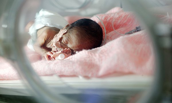 Picture shows a premature baby asleep in an incubator. New guidelines for nurses examine the stark decisions that arise when caring for extremely premature babies. 