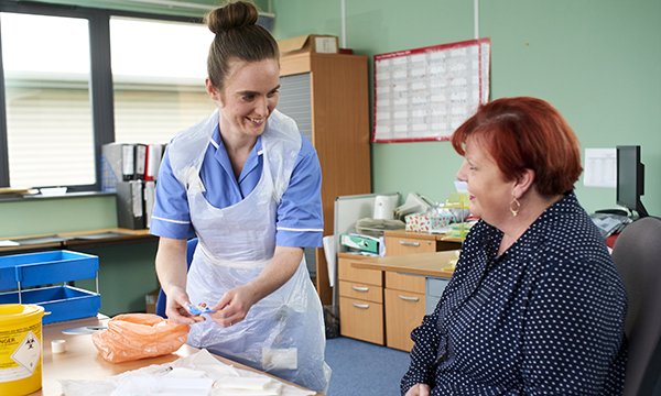 Picture shows nurse Sarah O'Donnell with patient Glenys Crisp. Nurses are helping cancer survivors to resume a normal routine by treating them at their workplace.