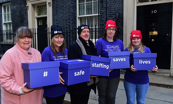 Danielle Tiplady, patients and RCN members hold boxes containing their safe staffing petitions in Downing Street