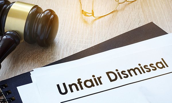 a judge's gavel beside document headed 'unfair dismissal'
