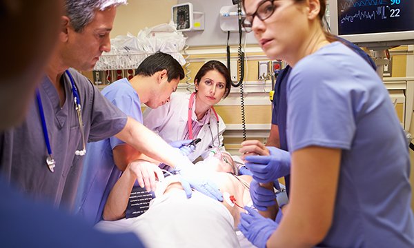 clinical team works on a patient