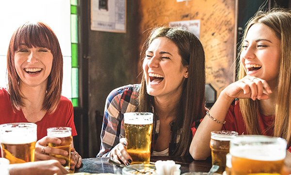 Stock image of off duty nurses socialising and drinking alcohol