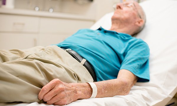 Frail older man lying on bed. Older people with frailty tend to present late and often in crisis at the emergency department