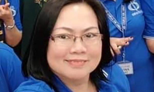 Picture shows Ana Lisa Labrador Sayson in her nurse's uniform