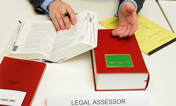 Picture of a legal assessor with reference books