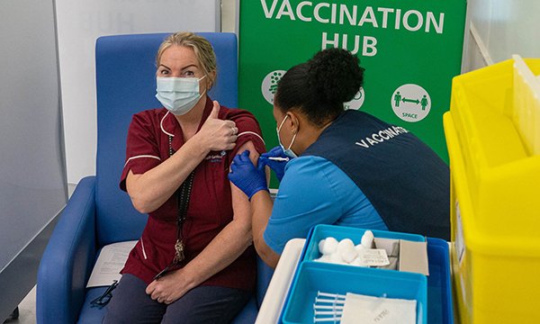 Healthcare worker receives her coronavirus jab as compulsory vaccination for NHS staff seems to move a step closer