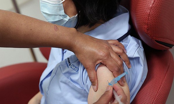 Nurse receives a coronavirus vaccine