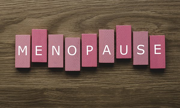 Pink wooden blocks lined up to spell the word 'menopause'