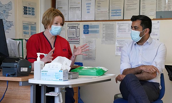 Scottish health and social care secretary Humza Yousaf listens to a briefing by advanced nurse practitioner Amanda Bendoris during a visit to Falkirk Community Hospital in 2022