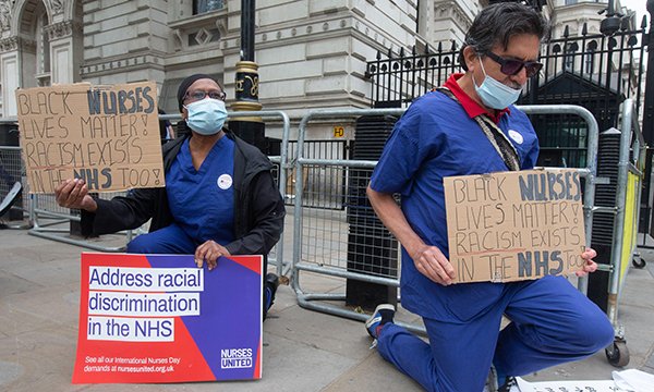 Two NHS workers supporting the Black Lives Matter movement demonstrate near Downing Street