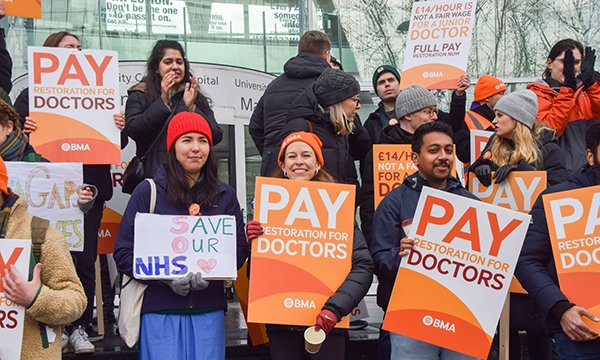 Striking junior doctors hold banners outside UCLH during their 72-hour BMA strike in England