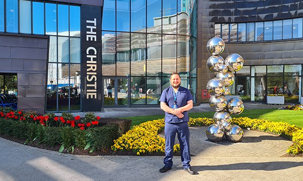 Breast cancer clinical nurse specialist Jacob Rosamond standing outside The Christie cancer treatment centre