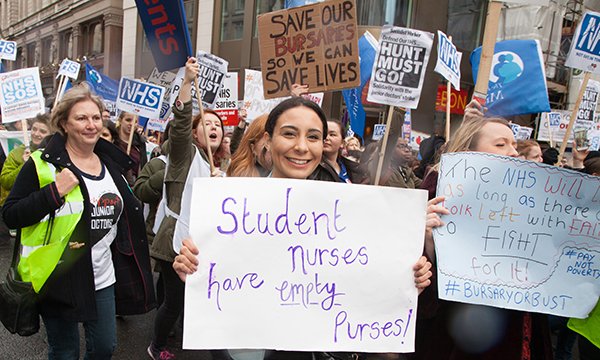 Nursing students hold placards in a march of protest against abolition of nursing bursary