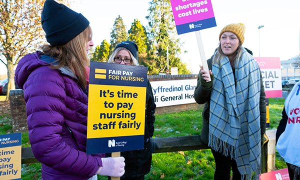 Nurses on the picket line with protest placards outside Glangwili General Hospital Carmarthen: RCN members in Wales are being asked to vote on an offer regarding non-pay elements after agreeing to pause strike action