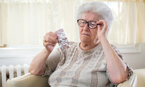 Confused woman taking a pill