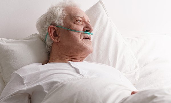 male in-patient lies in bed
